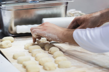 The chef prepares the dough for a meal in a restaurant or hotel in close-up