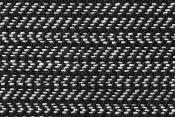 Gray wool pattern, textured salt and pepper style black and white melange upholstery. Fabric background copy space. Black and white herringbone