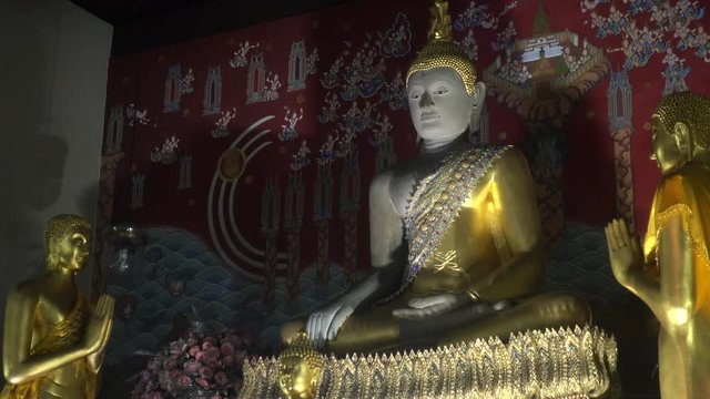 Medium of a Large Thai Buddhist Statue Meditating Surrounded by Smaller Statues