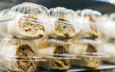 Pre-packaged sandwiches displayed in a commercial refrigerator