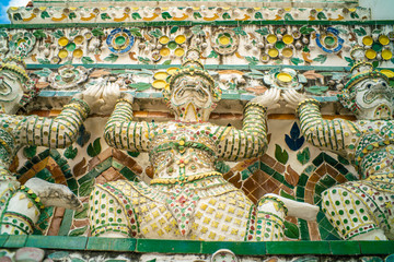 Giant stand statue in Wat Arun templeof dawn