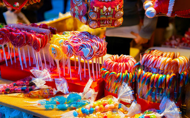 Lollipop candies in Christmas market in Germany Europe in winter. Sweet food at German Night street...