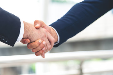 Two businessman shake hand for the first meeting. Two business people greeting outdoor.