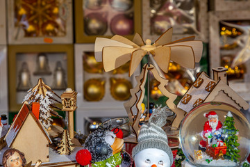 Tiny Christmas figures and Christmas baubles in a market stand on a German Christmas market