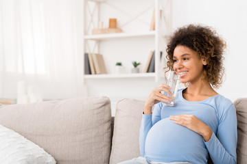 Obraz na płótnie Canvas Water balance. Pregnant woman drinking water at home