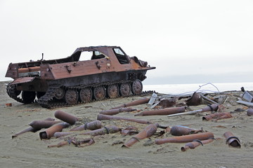 amphibious vehicle and piles of scrap metal waste in the Arctic