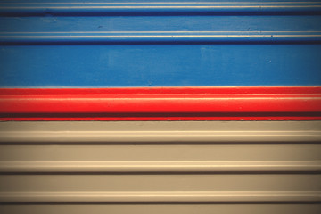 gray-blue background with a red stripe