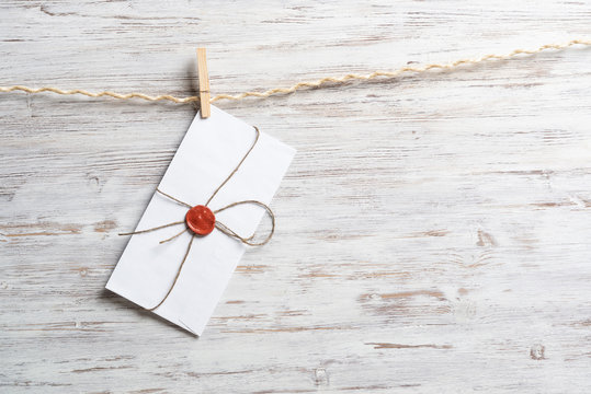 White classic envelope hanging on twine rope