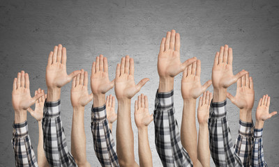 Row of man hands showing voting gesture