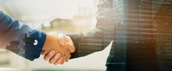 Close up of a business people with a handshake Agreements to do business together show trust and confidence in the investment in real estate. copy space of banner - obrazy, fototapety, plakaty