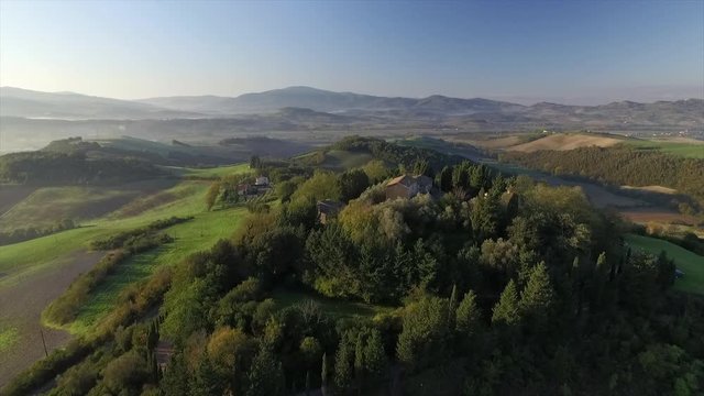 4k aerial  drone high fly footage over the Tuscany countryside hills and  the small ancien village of Gello near Volterra.