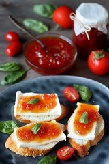 Jam from tomatoes with basil. toast with cheese and tomato jam. unusual jam. Turkish, French or Italian cuisine.