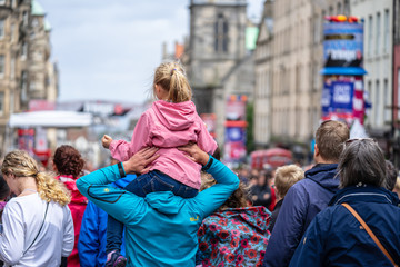 Little girl On Her Dads Shoulders.Edinburgh Festival Fringe.