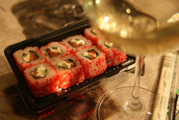 glass of white wine and Japanese rolls