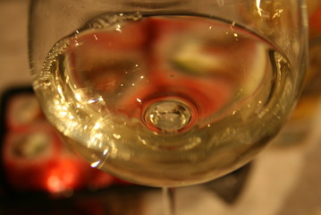in the foreground a glass of white wine