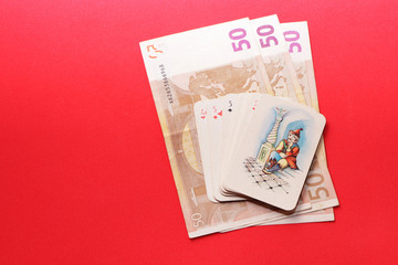 In the casino on the gaming table are cards and money.