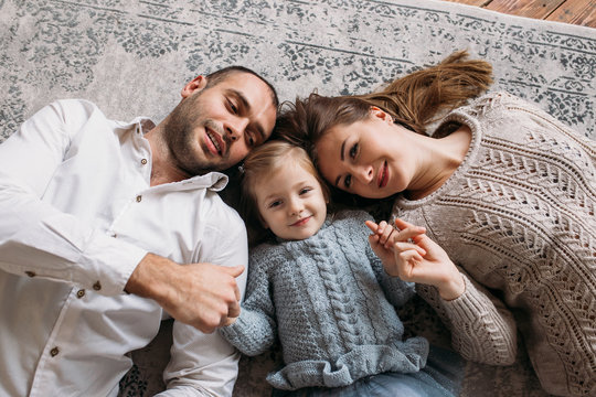 Happy family at home lying on the floor, have a fun and smiling