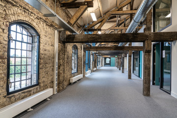 Interior of a former factory that has been restored. - obrazy, fototapety, plakaty