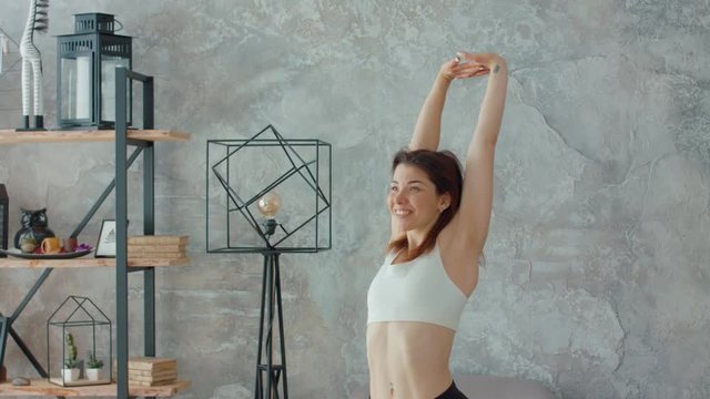 Smiling woman stretching her arms