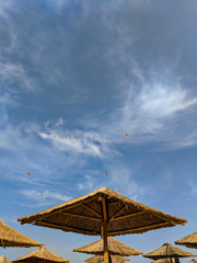 Reed Sun umbrellas on the beach against the blue sky