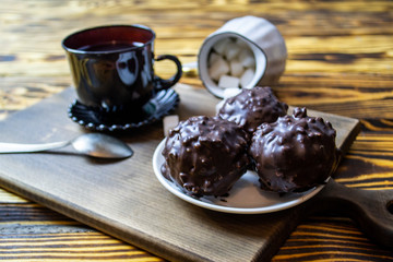 cup with tea near sugar bowl with tea and cookies