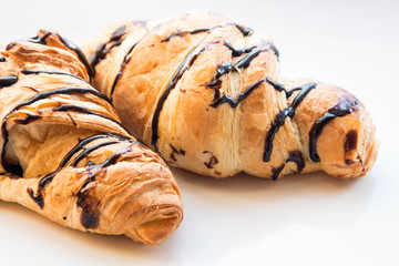 tasty chocolate croissants on a white background
