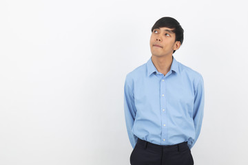 Young handsome asian business man thinking an idea while looking up isolated on white background.