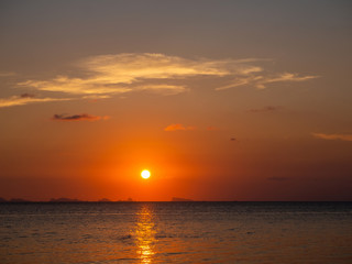 Solar path on the water. Hills and clouds on the horizon. Thailand