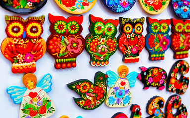 Wooden magnets as Christmas Tree Decorations on Christmas Market at Gendarmenmarkt in Winter Berlin, Germany. Wood figures on Advent Fair, and Stalls with Crafts Items in Bazaar.