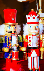 Wooden nutcrackers Christmas Tree Decorations on Christmas Market at Gendarmenmarkt in Winter Berlin, Germany. Wood nut crackers toys on Advent Fair, and Stalls with Crafts Items in Bazaar.