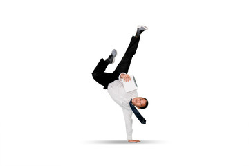 Businessman doing handstand over white background