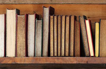 old books on wooden shelf.