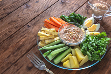 Dish from Indonesia. Gado-gado salad on a wooden background.