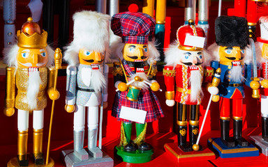 Wooden nutcrackers Christmas Tree Decorations on Christmas Market at Gendarmenmarkt in Winter Berlin, Germany. Wood nut crackers toys on Advent Fair, and Stalls with Crafts Items in Bazaar.