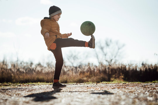 Young boy playing football outdoor