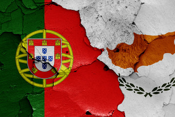 flags of Portugal and Cyprus painted on cracked wall