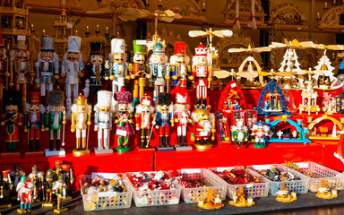 Obraz premium Wooden nutcrackers Christmas Tree Decorations on Christmas Market at Gendarmenmarkt in Winter Berlin, Germany. Wood nut crackers toys on Advent Fair, and Stalls with Crafts Items in Bazaar.