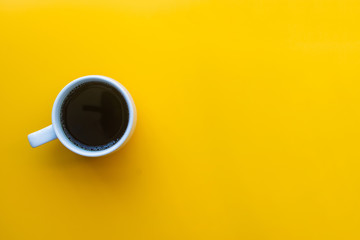 cup of coffee on yellow background. soft focus.