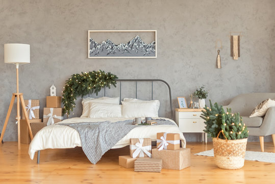 Gift boxes on wooden floor in Christmas decorated bedroom