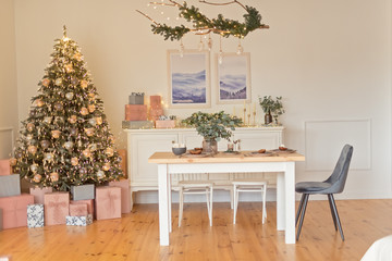 Served table over Christmas tree in Christmas decorated bedroom
