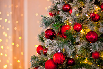 Decorated Christmas tree with bokeh on the background. Copy space for text.