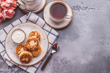 Cottage cheese pancakes with sour cream. Breakfast or lunch concept with copy space. Top view