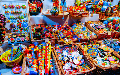 Fototapeta premium Wooden toys Christmas Tree Decorations on Christmas Market at Gendarmenmarkt in Winter Berlin, Germany. Wood figures on Advent Fair, and Stalls with Crafts Items in Bazaar.