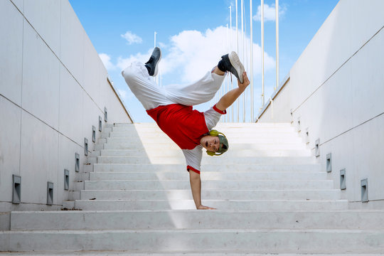 Dancer doing handstand on stairs