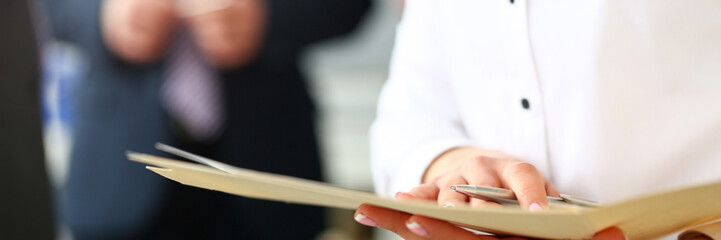 Female hands holding manila folder with important document