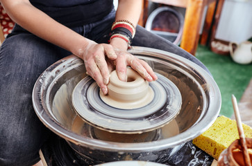 Woman's hands molding clay. Potter making ceramic pot in pottery workshop