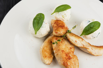 Grilled chicken breast with mozzarella cheese decorated with basil. Concept for a healthy meal.