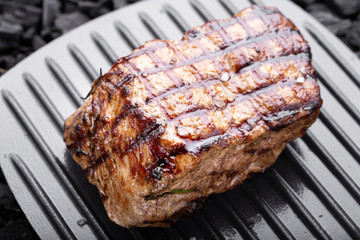 well-done steak on a black background