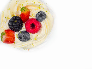 Meringue Pavlova with cream and fresh berries, strawberries, raspberries, blueberries isolated on white