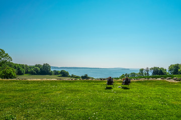 Fototapeta premium Jeløya, Norway. Landscape with green field and blue sky